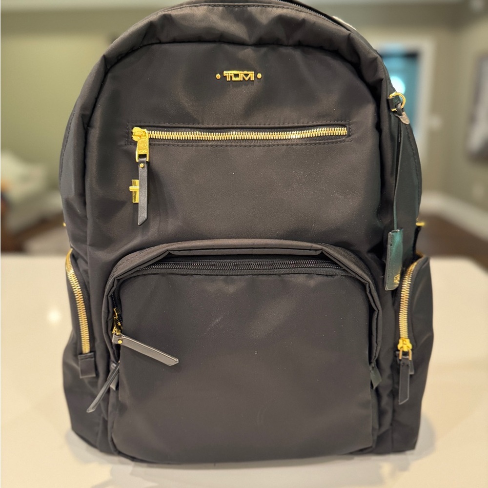 TUMI Black Backpack with Gold Accents